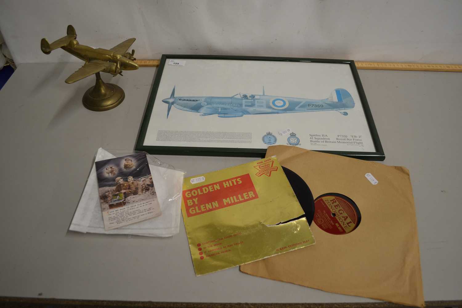 Coloured print of a Spitfire, a brass Spitfire ornament, Glenn Miller Golden Hits together with