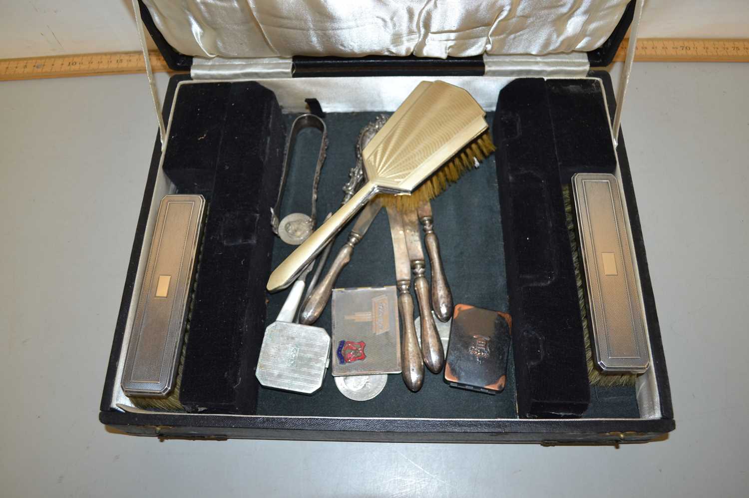 A case containing various dressing table brushes etc
