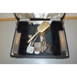 A case containing various dressing table brushes etc