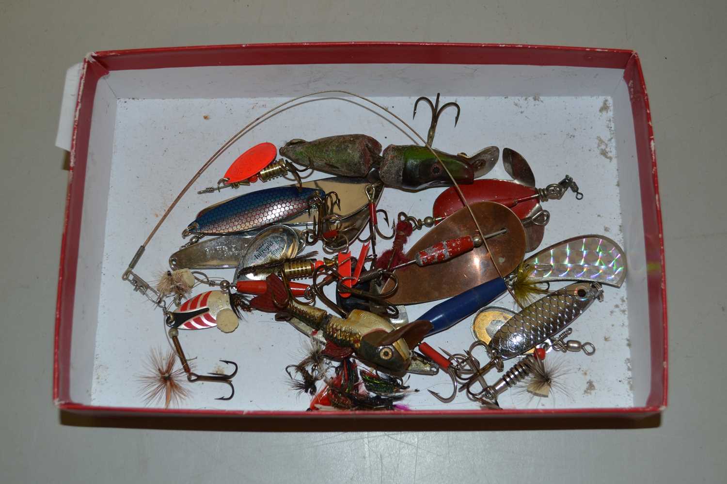 Small box of various fishing lures