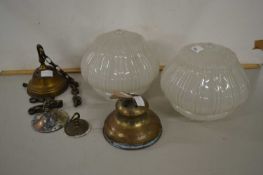 A pair of vintage light fittings with opaque glass shades
