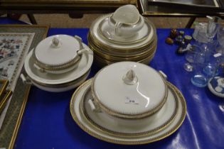 An early 20th Century part dinner service including serving tureens, gravy boat, large platters