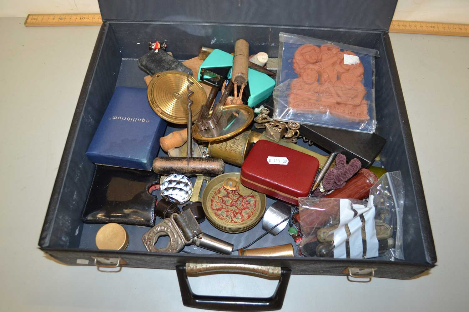 Black case containing various mixed items to include cigar cutter, pens, corkscrew, nut crackers