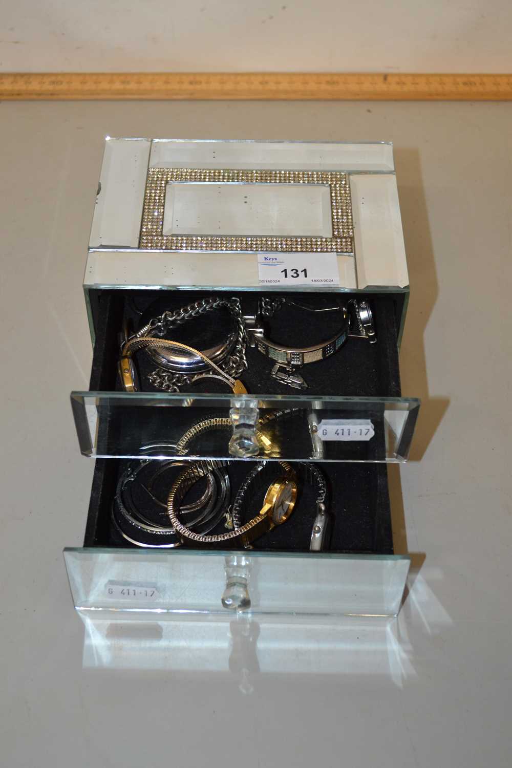 Small mirrored jewellery box containing assorted wristwatches