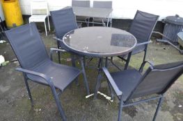 A black metal framed garden table and four chairs