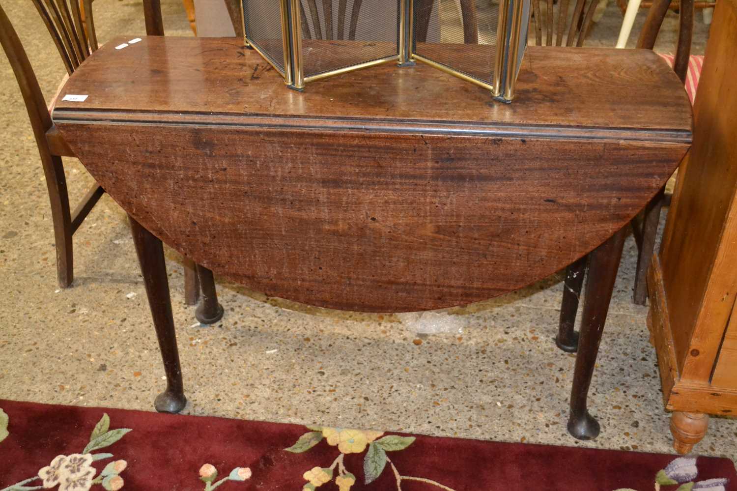 A Georgian mahogany drop leaf dining table on pad feet, 105cm wide