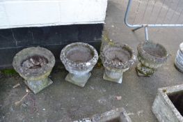 Four reconstituted stone planters on pedestals