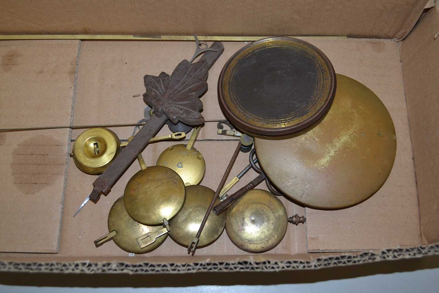 Box of various clock pendulums and other parts