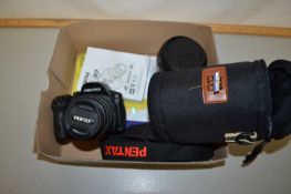 A Pentax K30 camera with accessories