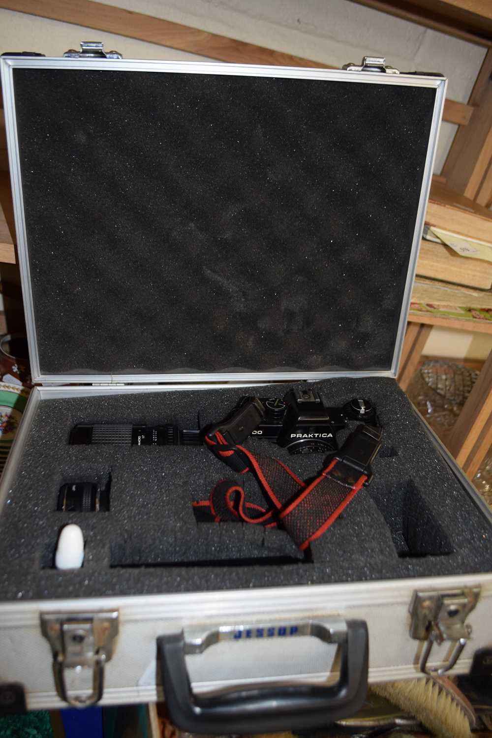 A Practika B100 SLR camera with lenses and accessories in hard case