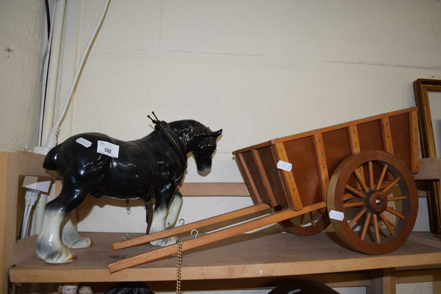 A ceramic shire horse and wooden cart