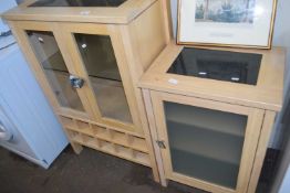 Marble topped cabinet with glass doors and another similar