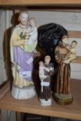 Pottery figure of a Saint holding a child together with two others similar and a small bust of a