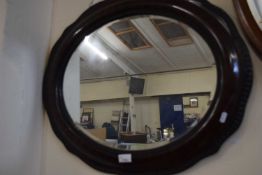 An oval wall mirror