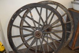 Two large cart wheels