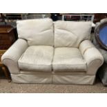 An oatmeal upholstered two seater sofa