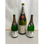 Three empty champagne bottles to include Moet & Chandon