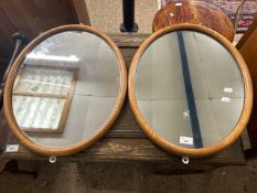 A pair of 20th Century light oak framed oval wall mirrors, 54cm high