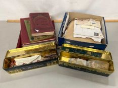 An accumulation of various world stamps housed in several albums, tins and a box of loose