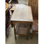 An early 20th Century oak drop leaf two tier table