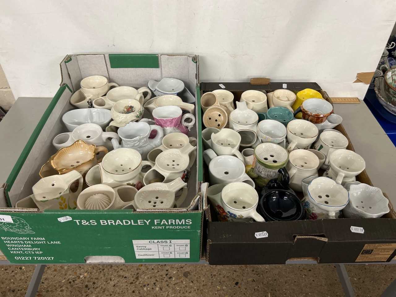 Two boxes containing a large collection of pottery shaving mugs