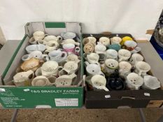 Two boxes containing a large collection of pottery shaving mugs