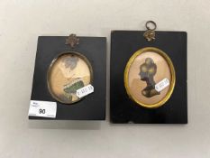 A pair of small oval framed portraits