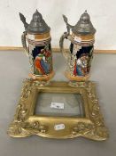 Pair of German beer steins and a gilt picture frame