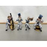 Group of four various continental porcelain musician figures