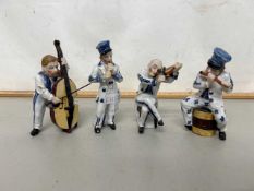 Group of four various continental porcelain musician figures