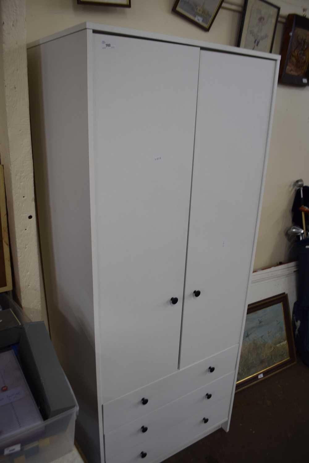 Modern white wardrobe with three drawers below