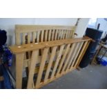 A pine framed single bed and a double bed head