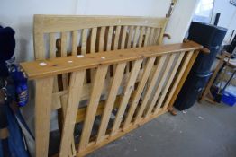 A pine framed single bed and a double bed head