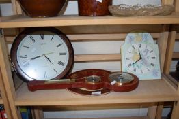 A faux red leather barometer wall clock and another