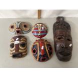 A group of contemporary Congolese pottery wall masks and a further carved wooden mask (5)