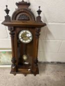 Late 19th or early 20th Century Vienna type wall clock in a carved architectural type case