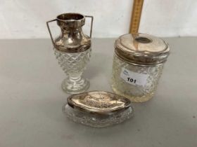 Group of two silver topped dressing table jars and a similar small silver topped glass vase