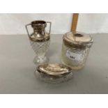 Group of two silver topped dressing table jars and a similar small silver topped glass vase