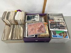Four boxes of various postcards