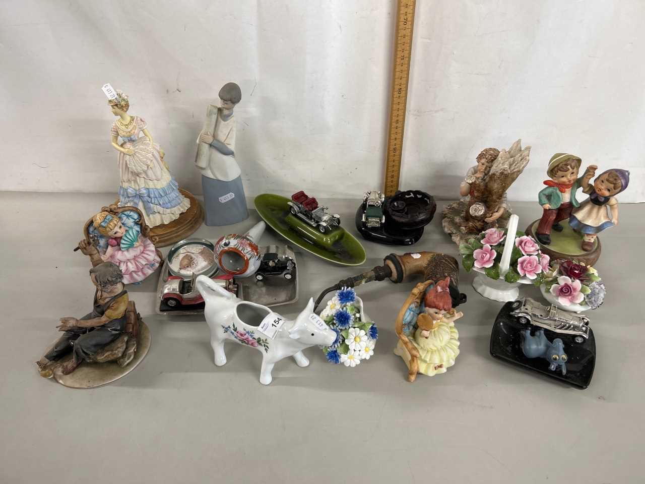 Group of various modern figurines to include Capodimonte plus further porcelain flowers, cow