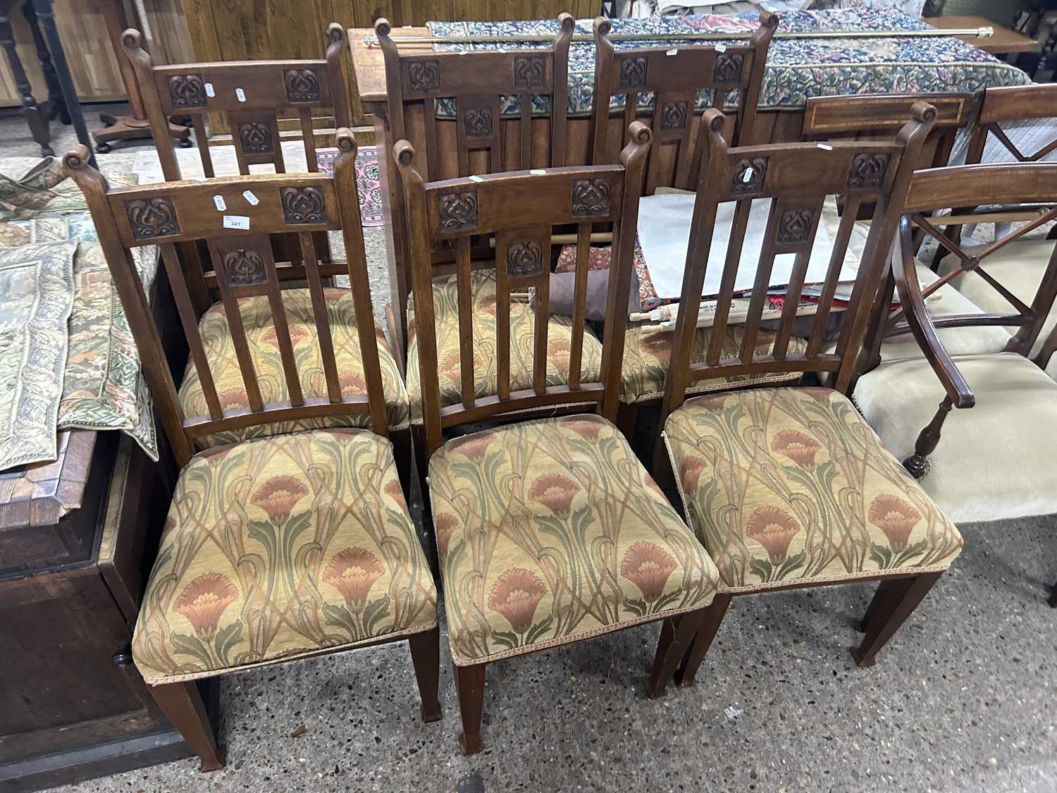 Set of six late Victorian oak framed dining chairs with carved decoration and floral upholstered