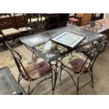 Modern iron framed glass top dining table with floral decoration together with four accompanying