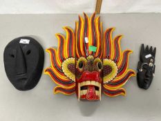 Group of three various carved wooden masks