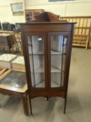 An Edwardian corner display cabinet