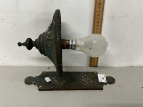 A brass wall light bearing GR sypher