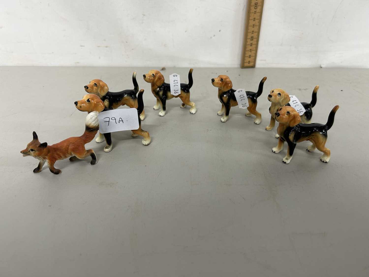 Collection of porcelain fox hounds and accompanying fox