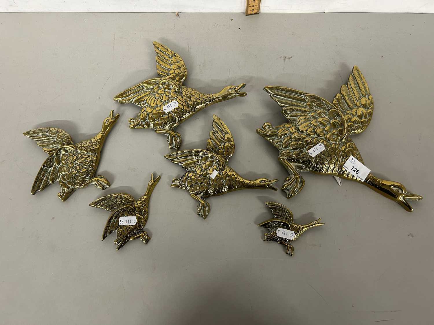 A graduated set of brass wall ducks