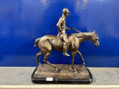 Comtemporary hollow bronze model of horse and jockey set on a polished marble plinth base
