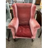 Dark pink upholstered Edwardian wing back armchair