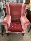 Dark pink upholstered Edwardian wing back armchair